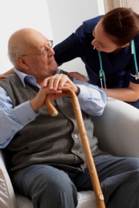 Senior man being visited by a nurse at home